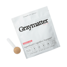 A pack of Graymatter Superfood Cognitive Support drink mix with a scoop beside it.